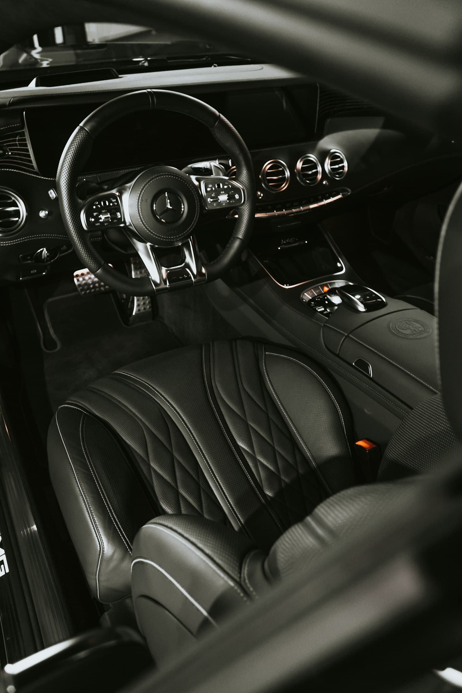 A clean, dark car interior with detailed console and seats